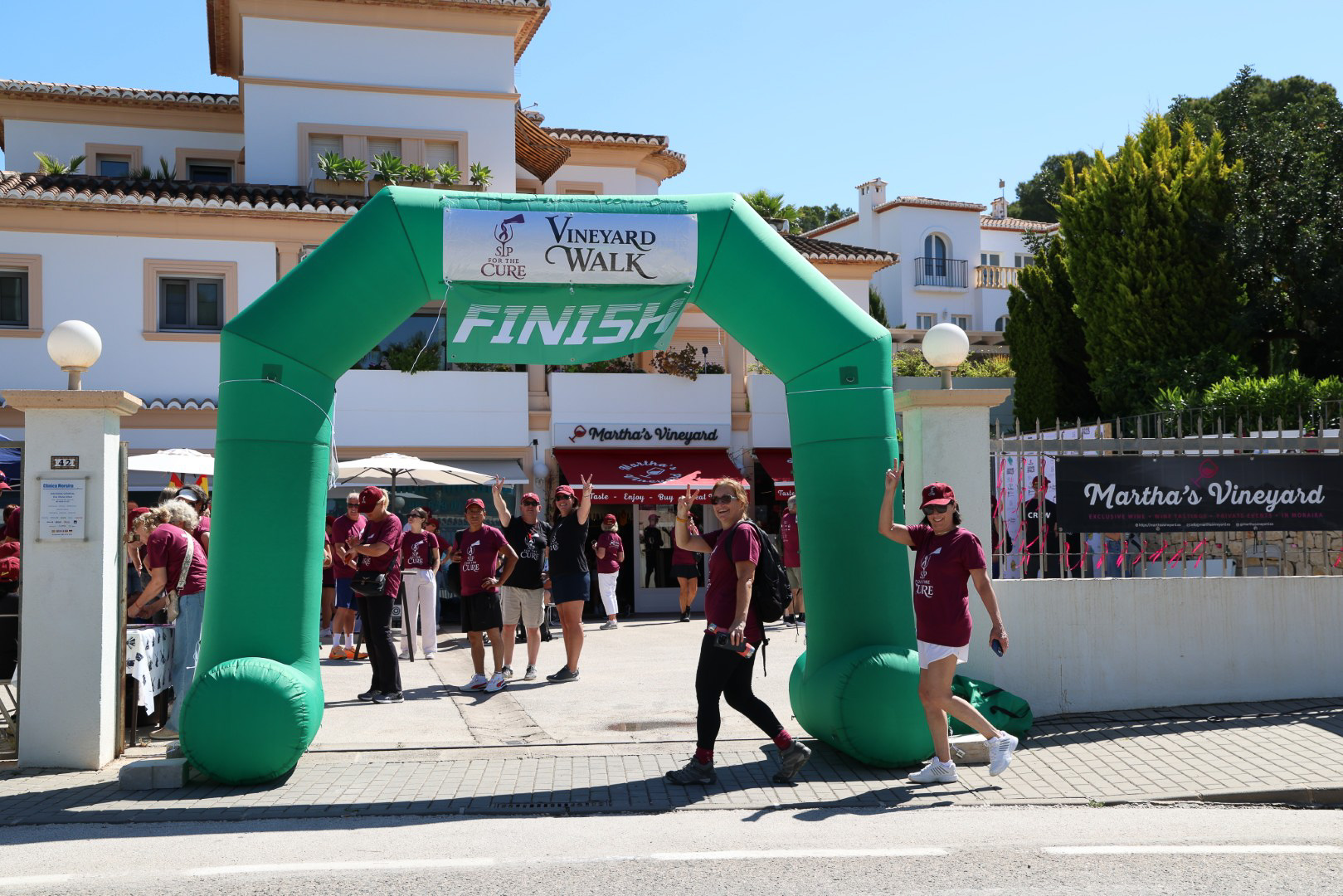 Walkers arriving at the finish line arch